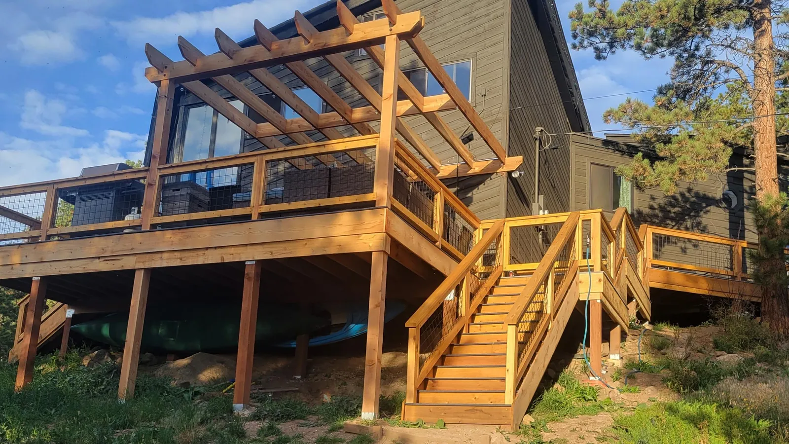 Cedar Deck with Pergola New cedar deck with a pergola overhead and wide wooden stairs down to the yard