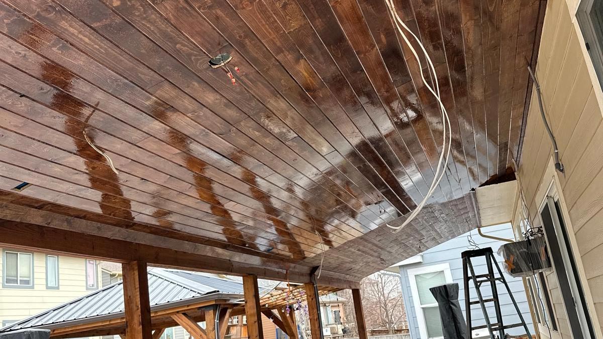 Covered Patio Wood Ceiling Covered patio with a stained tongue-and-groove wood plank ceiling and recessed lighting
