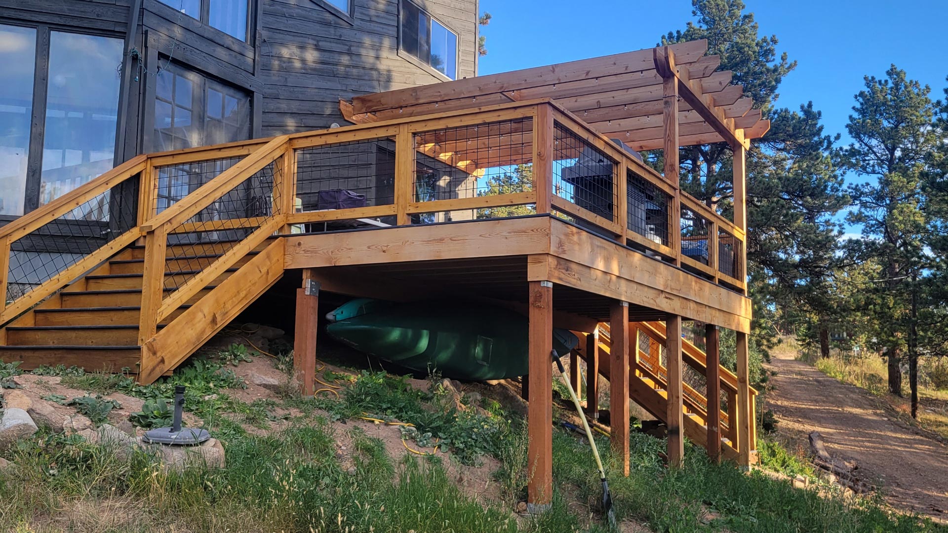 Elevated Deck & Pergola Side view of an elevated wood deck with pergola posts and beams above