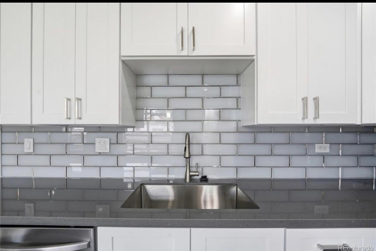 Subway Tile Backsplash Detail Close-up of a gray subway tile kitchen backsplash above an undermount sink with modern faucet