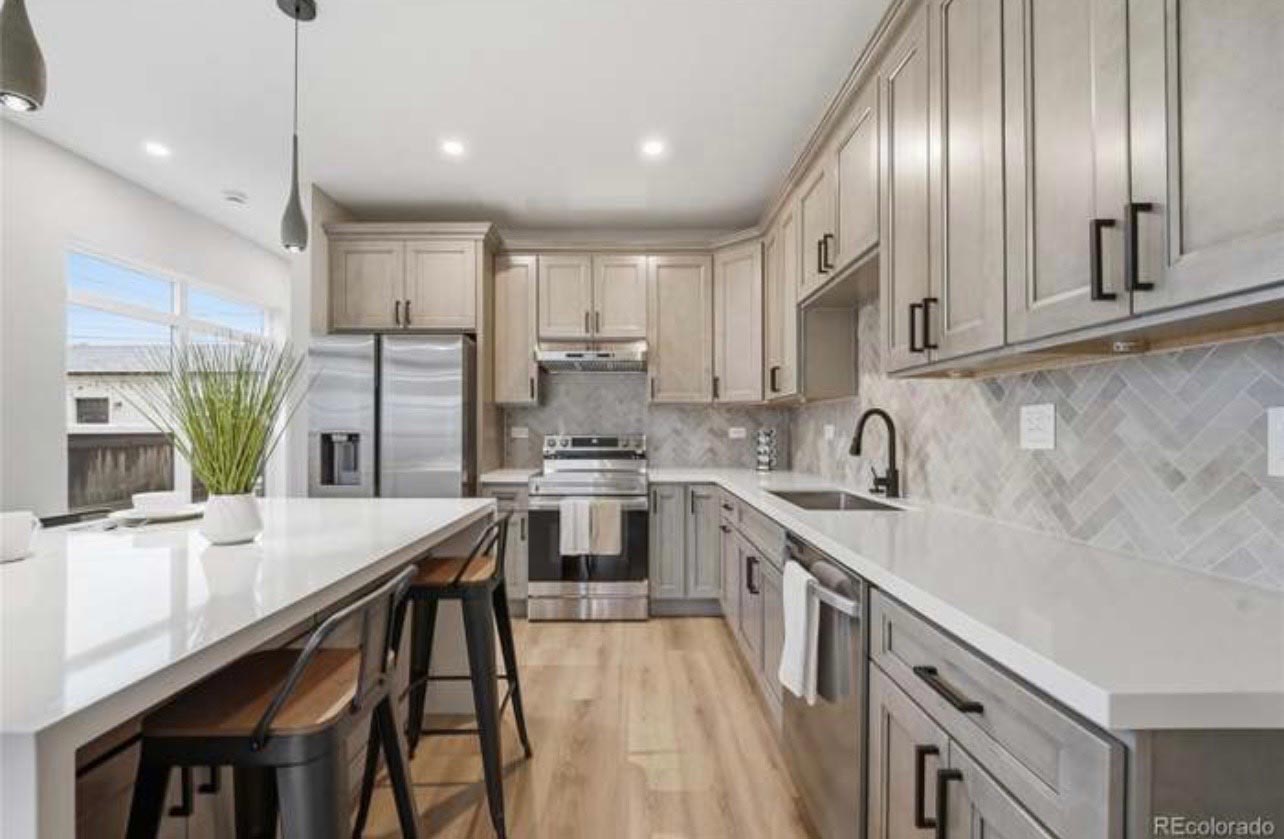 Gray Kitchen, Herringbone Tile Remodeled kitchen with gray shaker cabinets and a white herringbone tile backsplash