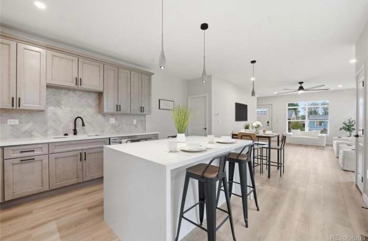 Open-Concept Gray Kitchen Open-concept kitchen with gray flat-panel cabinets and a white waterfall island