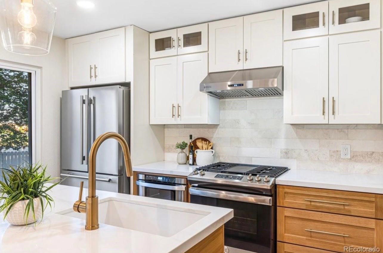Two-Tone Kitchen, Gas Range Two-tone kitchen with white upper cabinets, wood-tone lowers and a stainless gas range