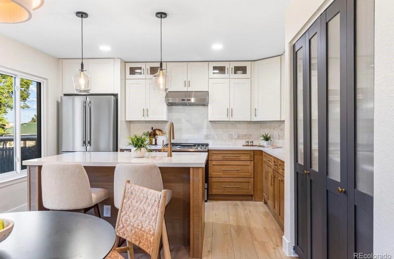 Two-Tone Kitchen Island Two-tone kitchen with white and wood cabinets around a quartz-topped island