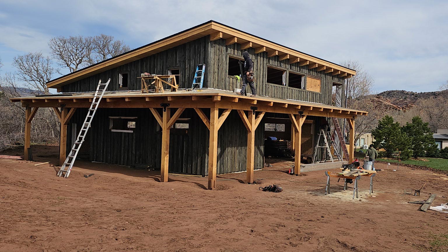 Weathered Vertical Siding Building exterior with weathered gray vertical wood siding and heavy timber posts