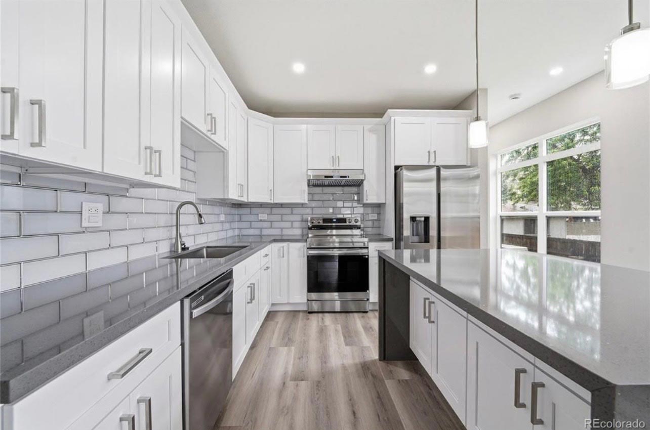 White Shaker Kitchen White shaker kitchen with gray subway tile backsplash and quartz countertops